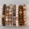 Gemstone & Swarovski Crystal Stretch Bracelets shown in 7mm Bronzite, Light Colorado Topaz Swarovski Crystal, 7mm Fossilized Agate, 10mm Jasper, Crystal (Clear) Swarovski Crystal, 7mm Botswana Agate, 7mm Mother of Pearl, Crystal Dorado Swarovski Stretch Bracelet, 7mm Tiger's Eye, Smoked Topaz Swarovski Crystal, 7mm Jasper