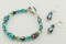 Two Crystal Earrings in Sterling Silver Metallic Blue.  Shown with the Basic Bracelet in Sterling Silver Antigua.